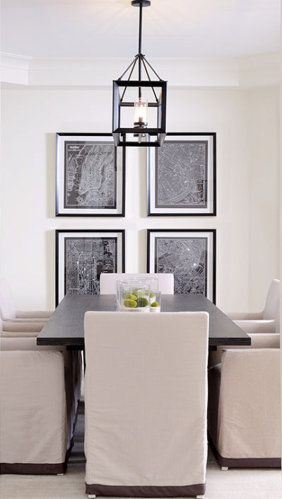 dining table with black tiled frames and black and white artwork