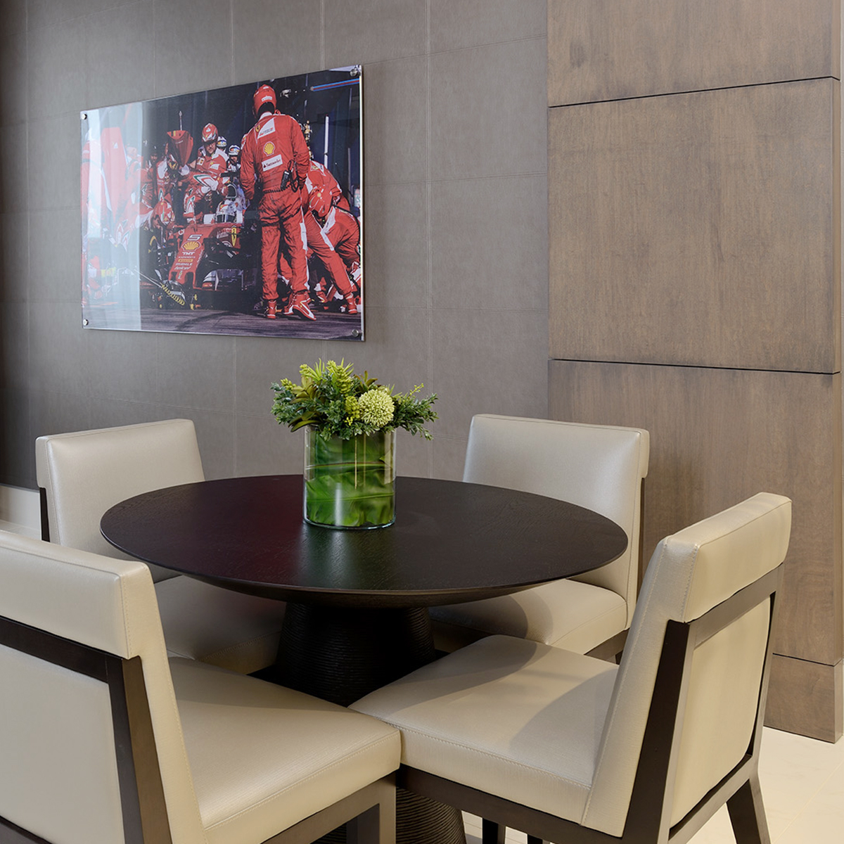 Modern industrial dining area with Ferrari artwork on the walls