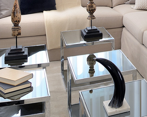 mirrored side tables with decorative accessories on top
