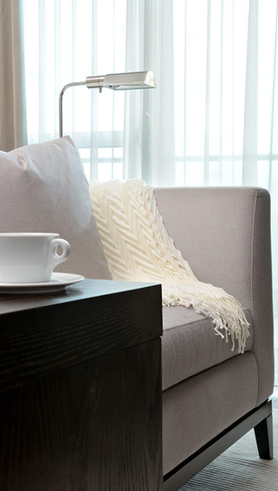 throw blanket on sofa with cappuccino on side table